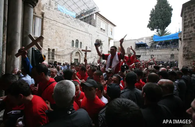 Christians Orthodox take part in Easter "Holy Fire" celebrations on the eve of Easter Sunday on April 23, 2011, outside the Church of the Holy Sepulchre, built over the sites where Christians believe Christ was crucified...