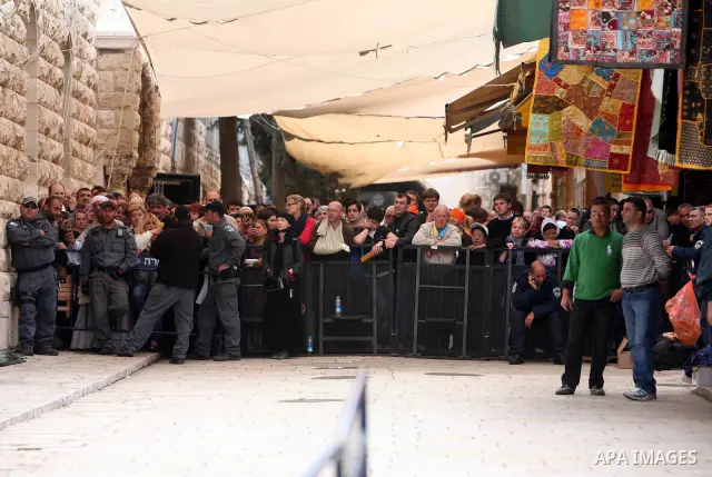 Israeli soldiers stand guard as Christians Orthodox take part in Easter "Holy Fire" celebrations on the eve of Easter Sunday on April 23, 2011, outside the Church of the Holy Sepulchre, built over the sites where Christi...