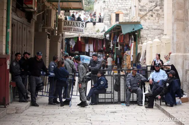 Israeli soldiers stand guard as Christians Orthodox take part in Easter "Holy Fire" celebrations on the eve of Easter Sunday on April 23, 2011, outside the Church of the Holy Sepulchre, built over the sites where Christi...