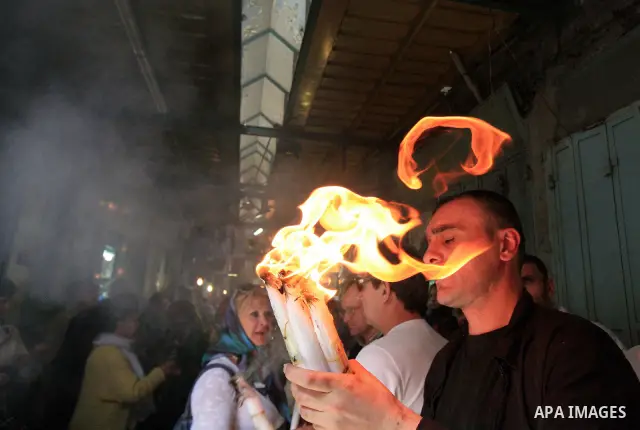 Christians Orthodox take part in Easter "Holy Fire" celebrations on the eve of Easter Sunday on April 23, 2011, outside the Church of the Holy Sepulchre, built over the sites where Christians believe Christ was crucified...