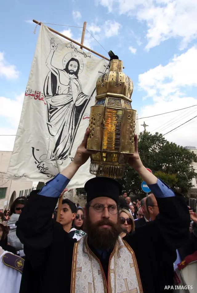 Christians take part in the opening of the Easter Vigil on Holy Saturday late April 23, 2011 in the West Bank town of Beit Jala. Christians of the western church are making their preparations for tomorrow's Easter celebr...