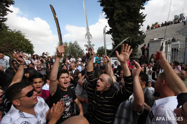 Christians take part in the opening of the Easter Vigil on Holy Saturday late April 23, 2011 in the West Bank town of Beit Jala. Christians of the western church are making their preparations for tomorrow's Easter celebr...
