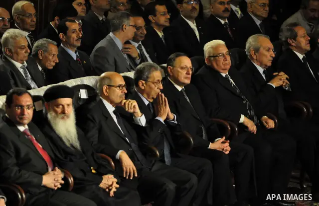 Egypt's presidential candidates Arab League Secretary-General Amr Moussa (R) and Mohamed el-Baradei talk during a Coptic Christian Easter service in the main cathedral in Cairo April 23, 2011. This year, the Orthodox and...