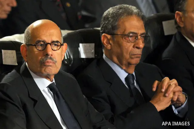 Egypt's presidential candidates Arab League Secretary-General Amr Moussa (R) and Mohamed el-Baradei sit during a Coptic Christian Easter service in the main cathedral in Cairo April 23, 2011. This year, the Orthodox and...