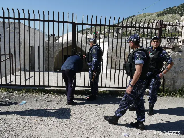 Members of the Palestinian police blocked the gate of "Joseph's Tomb" in Nablus, West Bank 24 April 2011.after his friend was shot dead by Palestinian policemen who fired on a group of Israeli pilgrims on their way to pr...