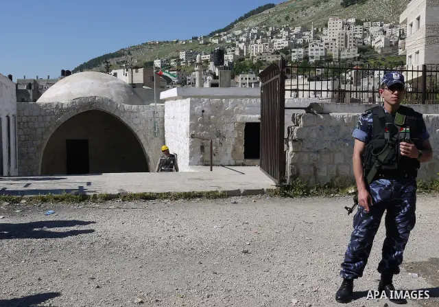 Members of the Palestinian police blocked the gate of "Joseph's Tomb" in Nablus, West Bank 24 April 2011.after his friend was shot dead by Palestinian policemen who fired on a group of Israeli pilgrims on their way to pr...