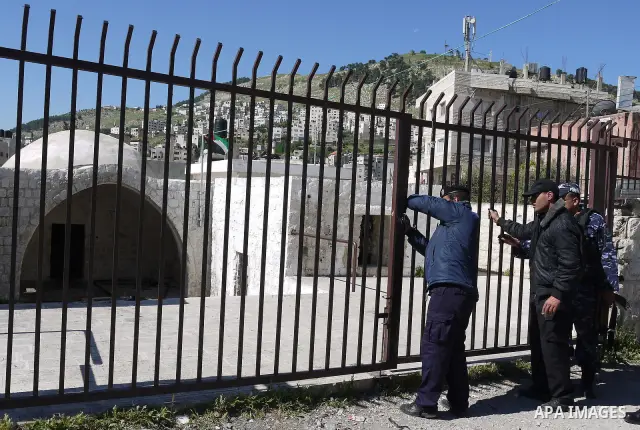 Members of the Palestinian police blocked the gate of "Joseph's Tomb" in Nablus, West Bank 24 April 2011.after his friend was shot dead by Palestinian policemen who fired on a group of Israeli pilgrims on their way to pr...