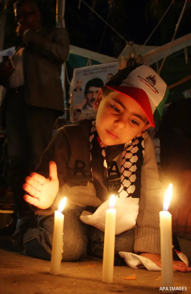 Palestinian lighting the candles in solidarity with the Syrian people in the West Bank city of Ramallah April 23, 2011. Photo by Issam Rimawi