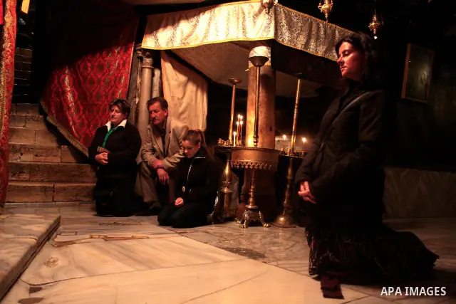Christian pilgrim pray in the Grotto, the alleged birthplace of Jesus Christ, in the Church of the Nativity during Sunday mass, April 24 2011.Photo by Najeh Hashlamoun..