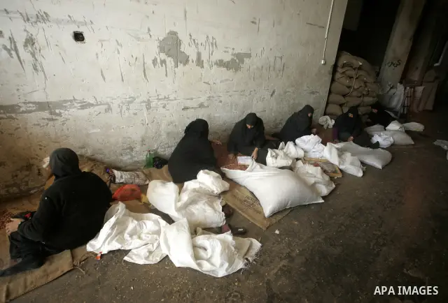 Palestinian women prepare peanut for selling at a toaster in the southern Gaza Strip town of Rafah on April 23, 2011. Palestinian women work as a result of the poverty rates which rose to high levels due to the Israeli b...