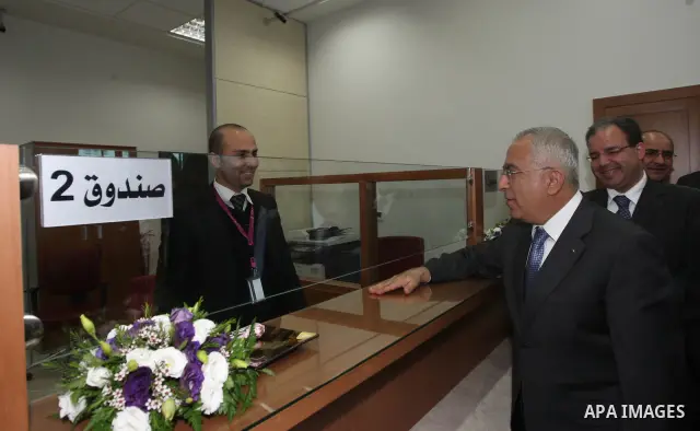 Palestinian Prime Minister, Salam Fayyad attends the opening celebration of the new branch of Palestine Bank in the West Bank city of Hebron on April 24, 2011. Photo by Mustafa Abu Dayeh