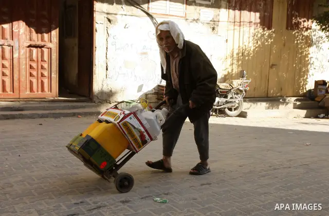 A Palestinian man fill bottles with water from a public tap in the United Nations Relief and Works Agency (UNRWA) headquarters in Rafah refugee camp in the southern of Gaza strip on April 26, 2011. Photo by Abed Rahim Kh...