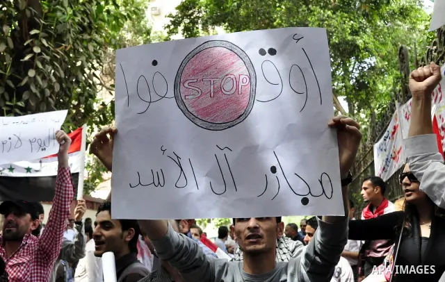 Syrians living in Egypt demonstrate against the recent actions of the Syrian government and in support of protesters, outside the Syrian Embassy on April 26, 2011. Syrian army units deployed in the city of Deraa which ha...