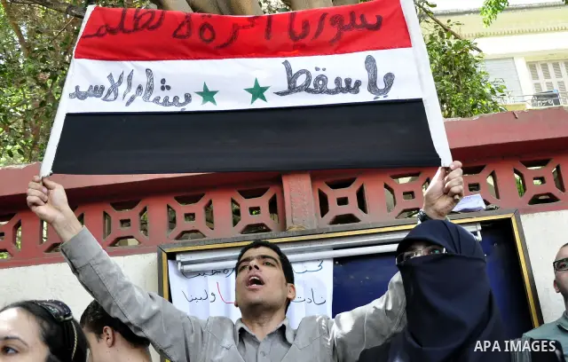 Syrians living in Egypt demonstrate against the recent actions of the Syrian government and in support of protesters, outside the Syrian Embassy on April 26, 2011. Syrian army units deployed in the city of Deraa which ha...