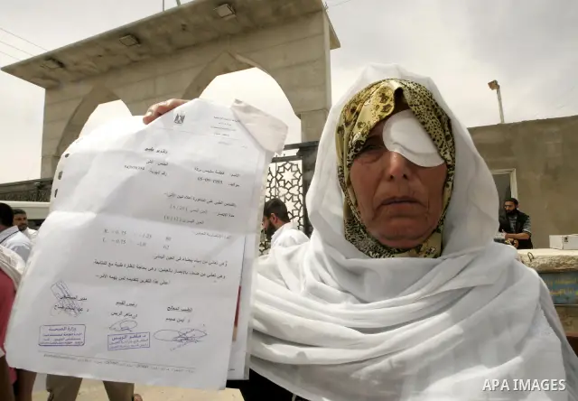 A Palestinian woman takes part in a protest organized by Palestinian doctors in front of the Rafah crossing border between Egypt and Gaza Strip on April ,27,2011, calling the new Egyptian government to open the crossing...