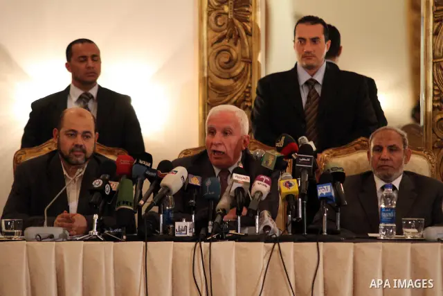 Palestinian Fatah delegation chief Azzam al-Ahmed speaks during a joint press conference with Hamas deputy leader Mussa Abu Marzuq and senior Hamas member Mahmud Zahar in Cairo on April 27, 2011 as the rival Palestinian...