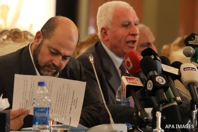Palestinian Fatah delegation chief Azzam al-Ahmed speaks during a joint press conference with Hamas deputy leader Mussa Abu Marzuq and senior Hamas member Mahmud Zahar in Cairo on April 27, 2011 as the rival Palestinian...