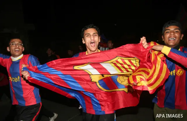 Palestinians youths celebrate the victory of the Spanish team Barcelona , in Gaza City on April. 27,2011. Barcelona celebrated their victory after the Spanish La Liga soccer match agalinst Real Madrid with Two goals. Pho...