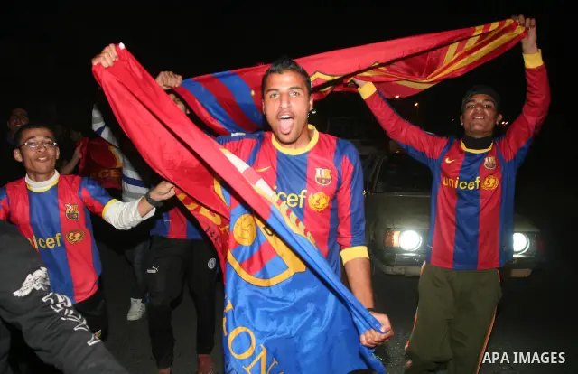 Palestinians youths celebrate the victory of the Spanish team Barcelona , in Gaza City on April. 27,2011. Barcelona celebrated their victory after the Spanish La Liga soccer match agalinst Real Madrid with Two goals. Pho...