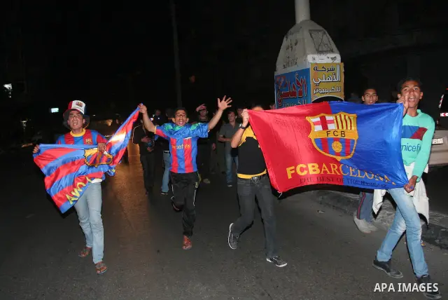 Palestinians youths celebrate the victory of the Spanish team Barcelona , in Gaza City on April. 27,2011. Barcelona celebrated their victory after the Spanish La Liga soccer match agalinst Real Madrid with Two goals. Pho...