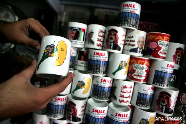 A Palestinian man display a cup painted with maps of Gaza Strip and the West Bank , in Gaza City on April 28, 2011 as Palestinians in the Gaza Strip and the West Bank welcomed reports that their rival Hamas and Fatah rul...