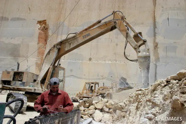 Palestinian labourers work at a quarry in the West Bank village of Taffouh near Hebron April 28, 2011. Stone and marble factories and quarries, located mainly in the West Bank cities of Bethlehem and Hebron, are at the c...