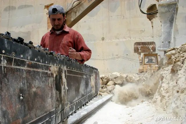 Palestinian labourers work at a quarry in the West Bank village of Taffouh near Hebron April 28, 2011. Stone and marble factories and quarries, located mainly in the West Bank cities of Bethlehem and Hebron, are at the c...