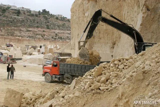 Palestinian labourers work at a quarry in the West Bank village of Taffouh near Hebron April 28, 2011. Stone and marble factories and quarries, located mainly in the West Bank cities of Bethlehem and Hebron, are at the c...