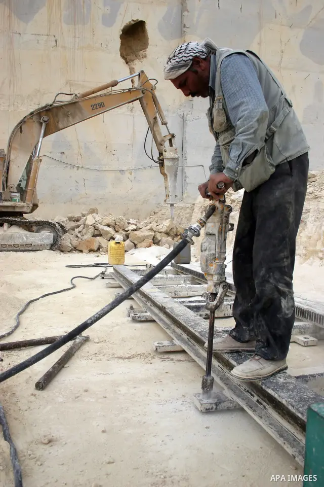 Palestinian labourers work at a quarry in the West Bank village of Taffouh near Hebron April 28, 2011. Stone and marble factories and quarries, located mainly in the West Bank cities of Bethlehem and Hebron, are at the c...