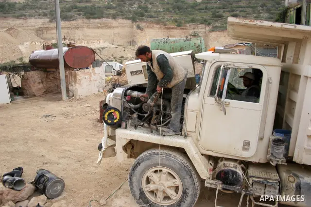 Palestinian labourers work at a quarry in the West Bank village of Taffouh near Hebron April 28, 2011. Stone and marble factories and quarries, located mainly in the West Bank cities of Bethlehem and Hebron, are at the c...