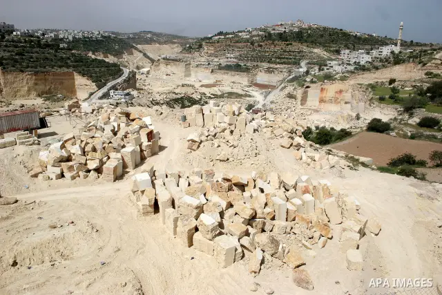 Palestinian labourers work at a quarry in the West Bank village of Taffouh near Hebron April 28, 2011. Stone and marble factories and quarries, located mainly in the West Bank cities of Bethlehem and Hebron, are at the c...