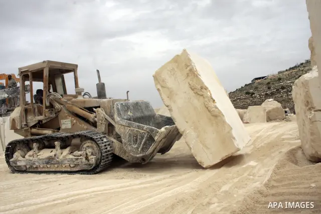 Palestinian labourers work at a quarry in the West Bank village of Taffouh near Hebron April 28, 2011. Stone and marble factories and quarries, located mainly in the West Bank cities of Bethlehem and Hebron, are at the c...
