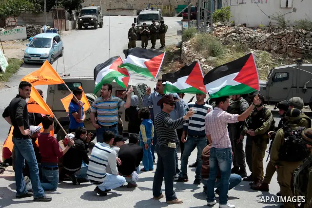 Protesters argue with Israeli soldiers during a demonstration against Israel's controversial separation barrier in the West Bank village of Maasarah, near the biblical town of Bethlehem on April 29, 2011.Israel says the...