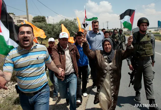 Protesters argue with Israeli soldiers during a demonstration against Israel's controversial separation barrier in the West Bank village of Maasarah, near the biblical town of Bethlehem on April 29, 2011.Israel says the...