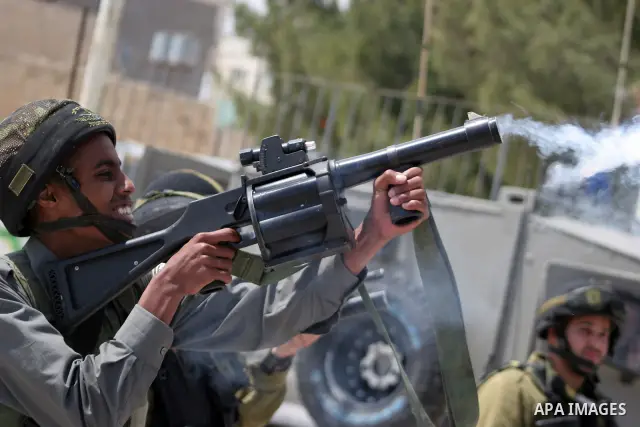 Protesters argue with Israeli soldiers during a demonstration against Israel's controversial separation barrier in the West Bank village of Maasarah, near the biblical town of Bethlehem on April 29, 2011.Israel says the...