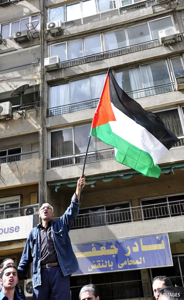 Egyptian protesters wave the Palestinian flag during a demonstration in front of the Israeli embassy in Cairo on April 29, 2011, calling for opening the border with the Gaza Strip and in support with Palestinian unity be...