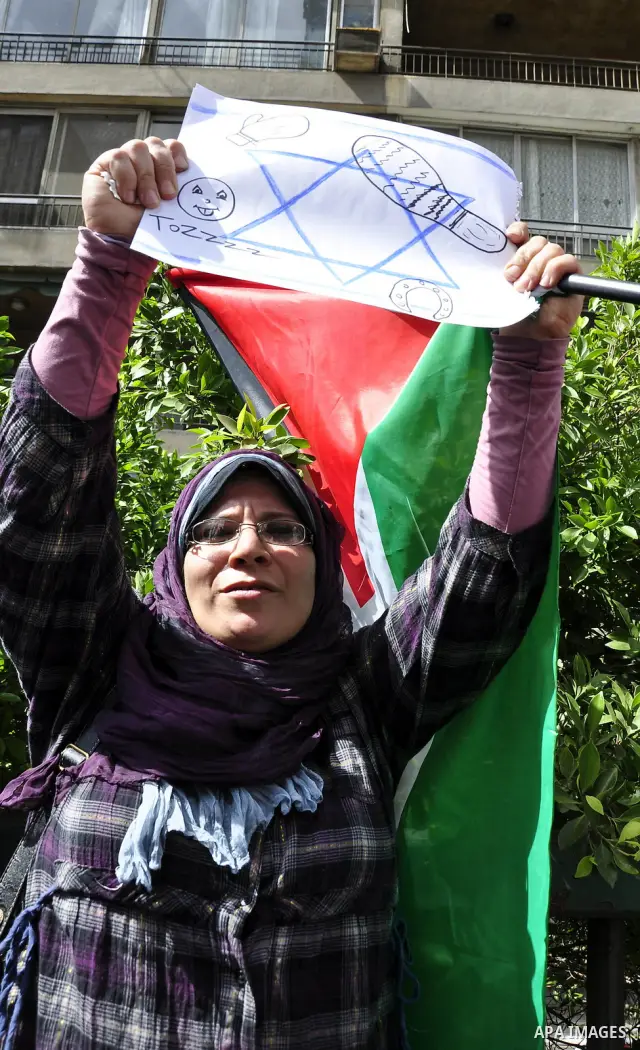 Egyptian protesters wave the Palestinian flag during a demonstration in front of the Israeli embassy in Cairo on April 29, 2011, calling for opening the border with the Gaza Strip and in support with Palestinian unity be...