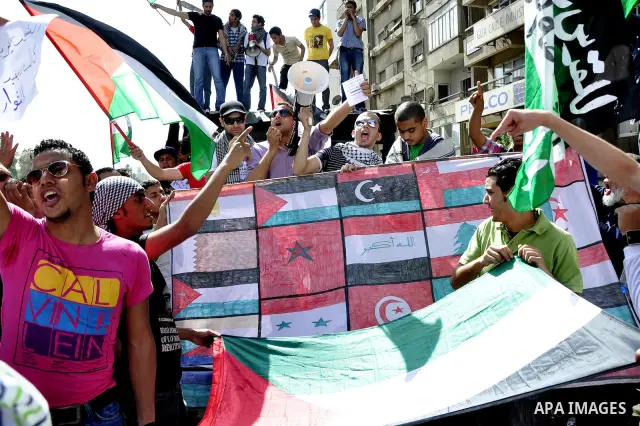 Egyptian protesters wave the Palestinian flag during a demonstration in front of the Israeli embassy in Cairo on April 29, 2011, calling for opening the border with the Gaza Strip and in support with Palestinian unity be...
