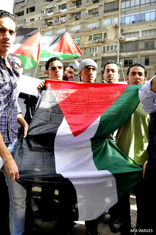 Egyptian protesters wave the Palestinian flag during a demonstration in front of the Israeli embassy in Cairo on April 29, 2011, calling for opening the border with the Gaza Strip and in support with Palestinian unity be...