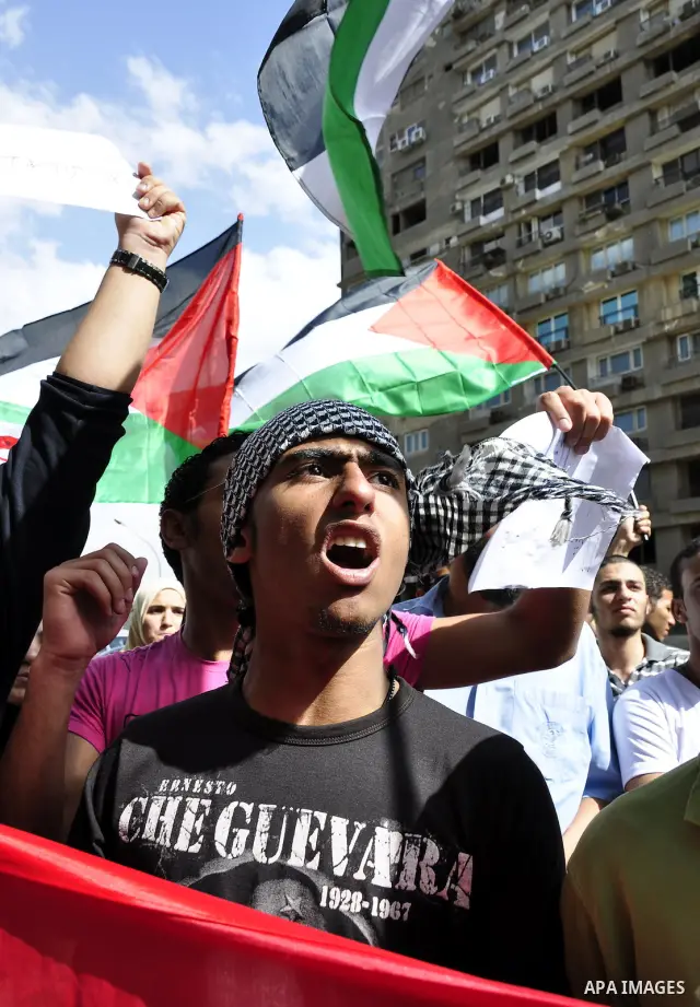 Egyptian protesters wave the Palestinian flag during a demonstration in front of the Israeli embassy in Cairo on April 29, 2011, calling for opening the border with the Gaza Strip and in support with Palestinian unity be...