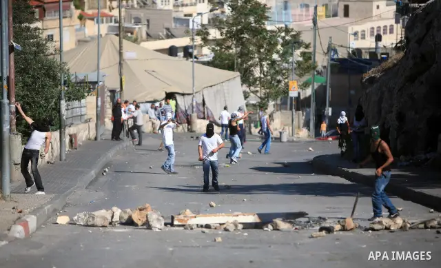 Palestinian youths hurl stones toward Israeli soldiers during clashes in the flashpoint east Jerusalem neighbourhood of Silwan on April 29, 2011.. Photo by Sliman Khader