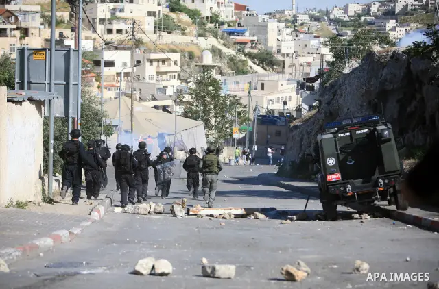 An Israeli soldier fires tear gas canisters towards Palestinian youths during clashes in the flashpoint east Jerusalem neighbourhood of Silwan on April 29, 2010.. Photo by Sliman Khader