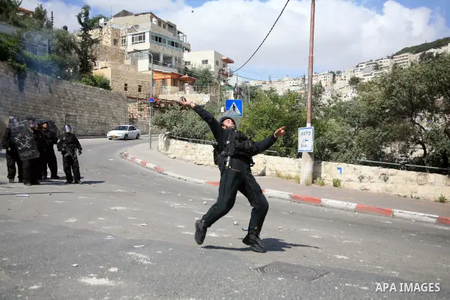 An Israeli soldier fires tear gas canisters towards Palestinian youths during clashes in the flashpoint east Jerusalem neighbourhood of Silwan on April 29, 2010.. Photo by Sliman Khader