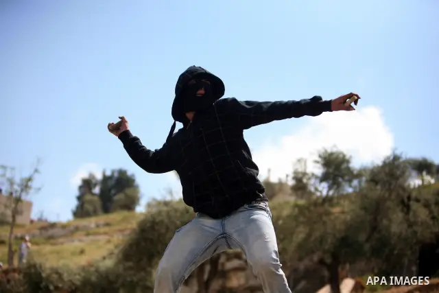 Palestinian youths hurl stones toward Israeli soldiers during clashes in the flashpoint east Jerusalem neighbourhood of Silwan on April 29, 2011.. Photo by Sliman Khader