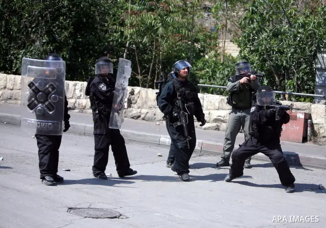 An Israeli soldier fires tear gas canisters towards Palestinian youths during clashes in the flashpoint east Jerusalem neighbourhood of Silwan on April 29, 2010.. Photo by Sliman Khader
