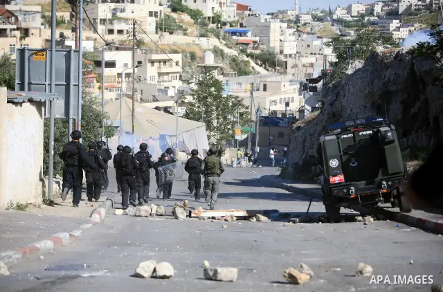 An Israeli soldier fires tear gas canisters towards Palestinian youths during clashes in the flashpoint east Jerusalem neighbourhood of Silwan on April 29, 2010.. Photo by Sliman Khader