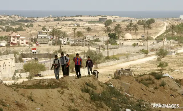 Palestinian boys walk near Rafah close to the border between Egypt and the southern Gaza Strip on April 30, 2011, a day after Egypt said it will permanently open the Rafah border crossing as part of its plans to ease the...
