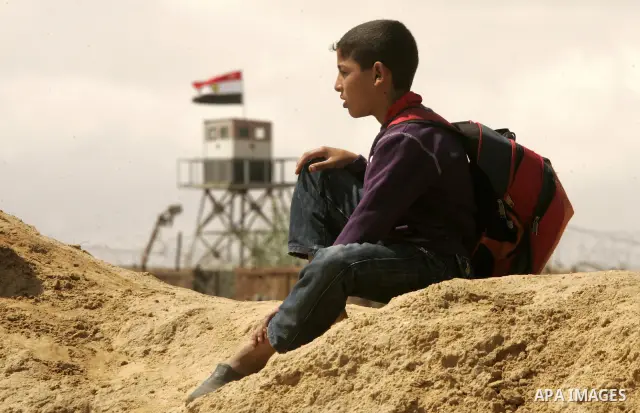 Palestinian boys walk near Rafah close to the border between Egypt and the southern Gaza Strip on April 30, 2011, a day after Egypt said it will permanently open the Rafah border crossing as part of its plans to ease the...