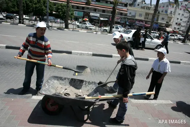 Palestinian boys Participate in cleaning streets and planting olive trees during a campaign organized by Hamas in Gaza City on May 1, 2011 . Photo by Mohammed Othman.