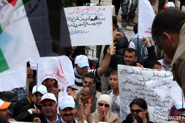 Palestinians hold a rally in the city of Ramallah in the Israeli occupied West Bank during May Day celebrations demanding jobs, freedom of movement between towns and cities currently restricted by Israeli army checkpoint...